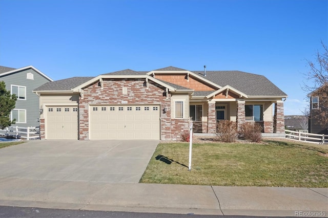 craftsman-style home featuring a front yard and a garage