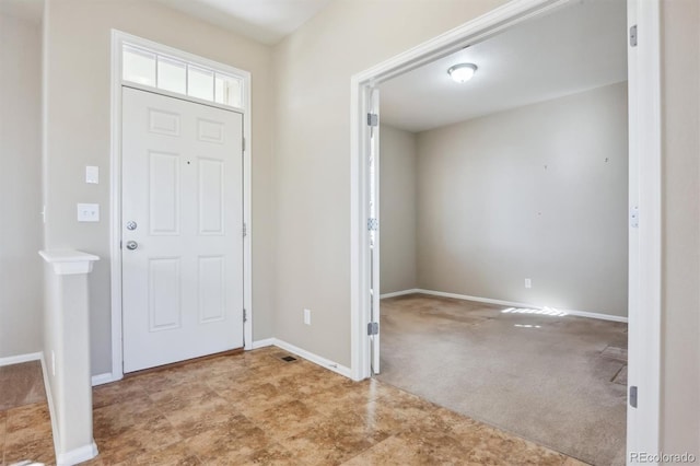 foyer entrance featuring light carpet