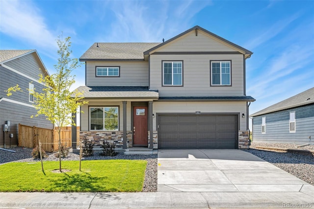 craftsman-style house with a garage and a front lawn