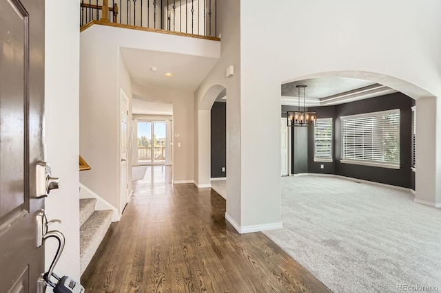 1905 Graphite Ct, Castle Rock, CO 80108 - foyer entrance featuring arched walkways, a chandelier, stairs, wood finished floors, and recessed lighting