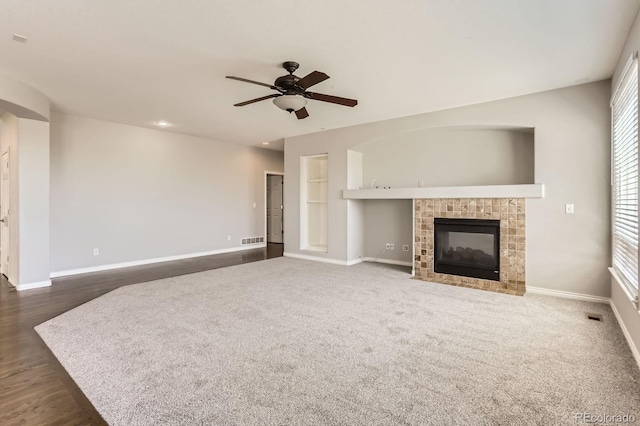 1905 Graphite Ct, Castle Rock, CO 80108 - unfurnished living room with ceiling fan, a fireplace, and dark wood-style floors