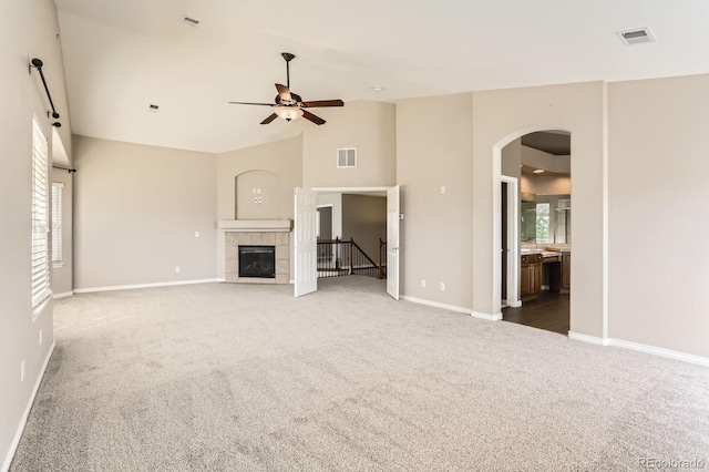 1905 Graphite Ct, Castle Rock, CO 80108 - unfurnished living room with carpet, plenty of natural light, arched walkways, ceiling fan, and high vaulted ceiling