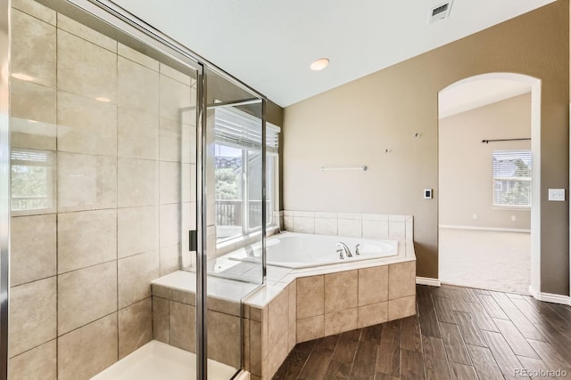 1905 Graphite Ct, Castle Rock, CO 80108 - bathroom featuring a garden tub, a shower stall, wood finished floors, and lofted ceiling