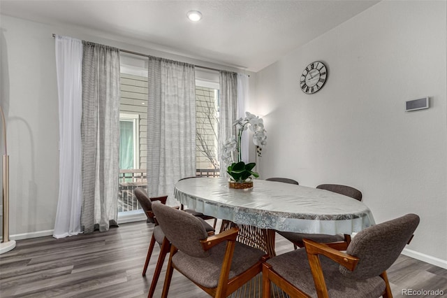 dining area with dark hardwood / wood-style floors