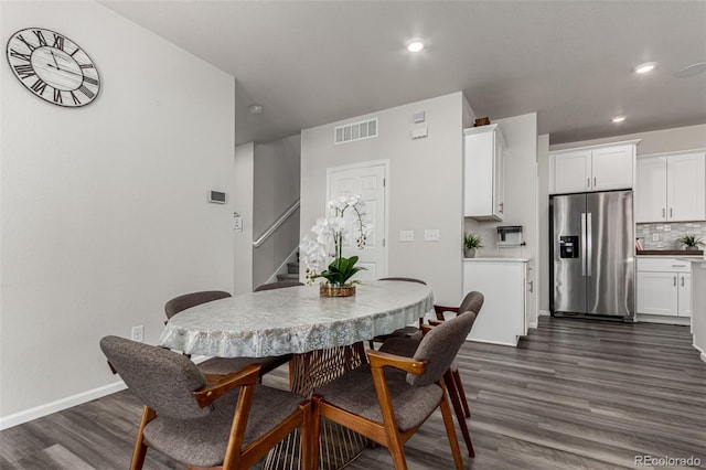 dining space with dark hardwood / wood-style flooring