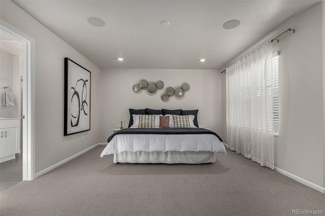 carpeted bedroom featuring ensuite bathroom