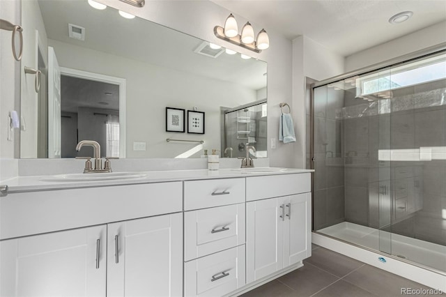 bathroom featuring tile patterned floors, vanity, and walk in shower