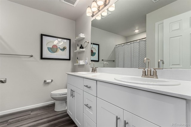 bathroom featuring a shower with curtain, vanity, hardwood / wood-style flooring, and toilet