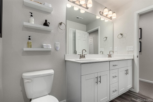 bathroom featuring hardwood / wood-style floors, vanity, and toilet