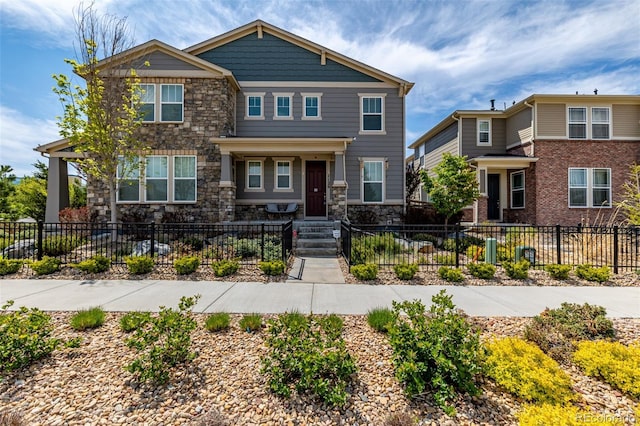 1126 S Yampa St, Aurora, CO 80017 - craftsman house with stone siding and a fenced front yard