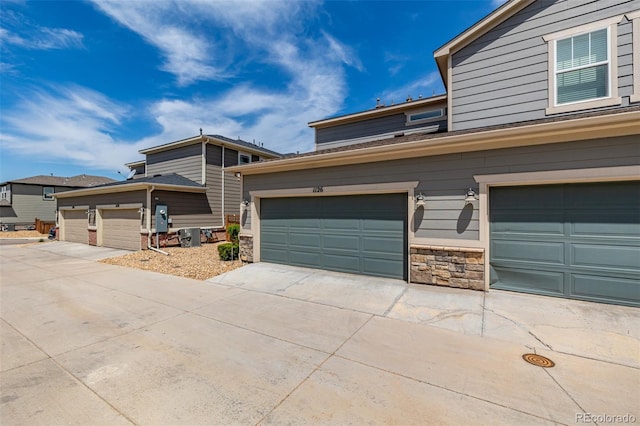 1126 S Yampa St, Aurora, CO 80017 - traditional home with stone siding, an attached garage, and driveway