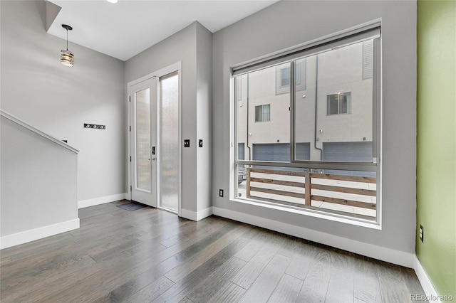 interior space featuring plenty of natural light and dark hardwood / wood-style flooring