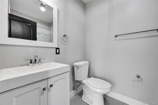 bathroom featuring toilet and vanity