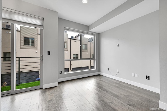 unfurnished room with hardwood / wood-style floors