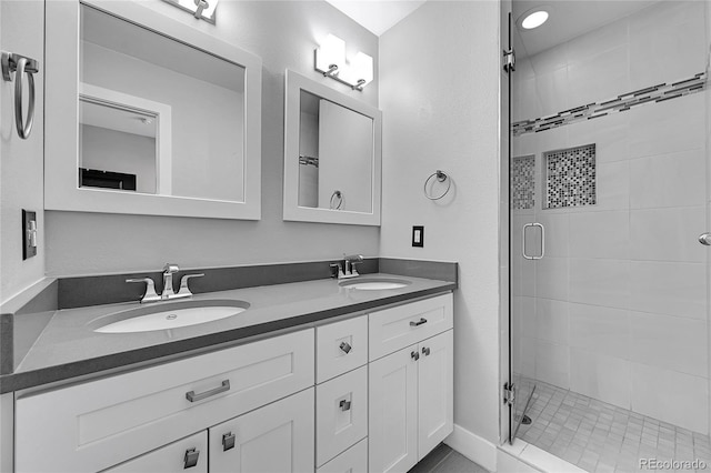 bathroom with walk in shower and vanity