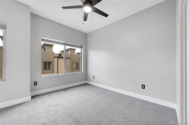 carpeted empty room featuring ceiling fan