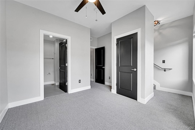 unfurnished bedroom featuring carpet flooring, connected bathroom, and ceiling fan