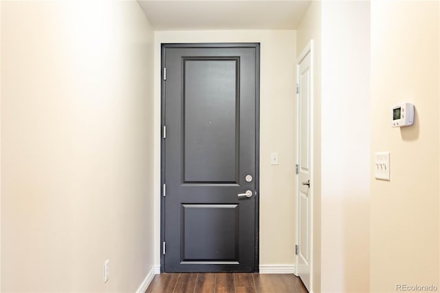 entryway with baseboards and dark wood finished floors