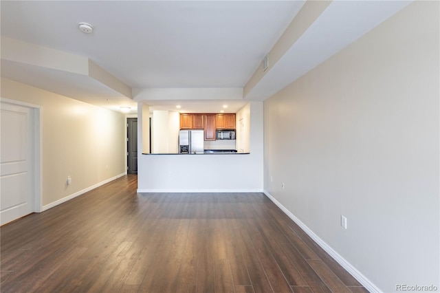 unfurnished living room with dark wood-style floors, visible vents, baseboards, and recessed lighting