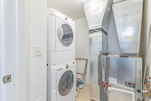 laundry area featuring stacked washer and dryer and laundry area