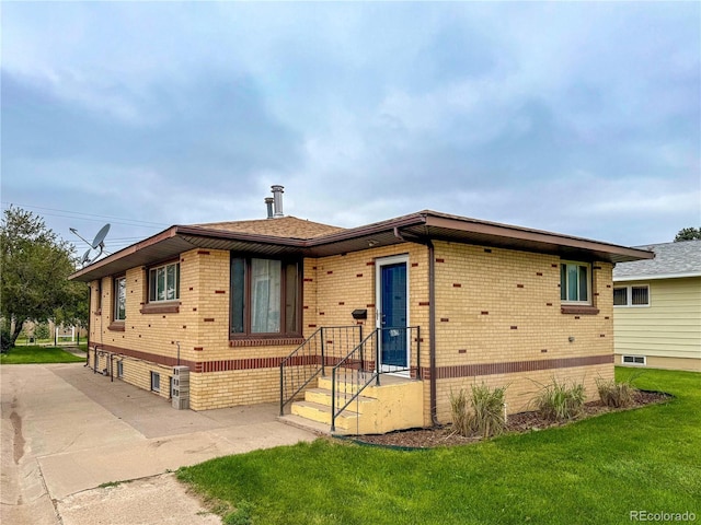 163 Pomeroy St, Burlington, CO 80807 - view of front of house with brick siding and a front lawn
