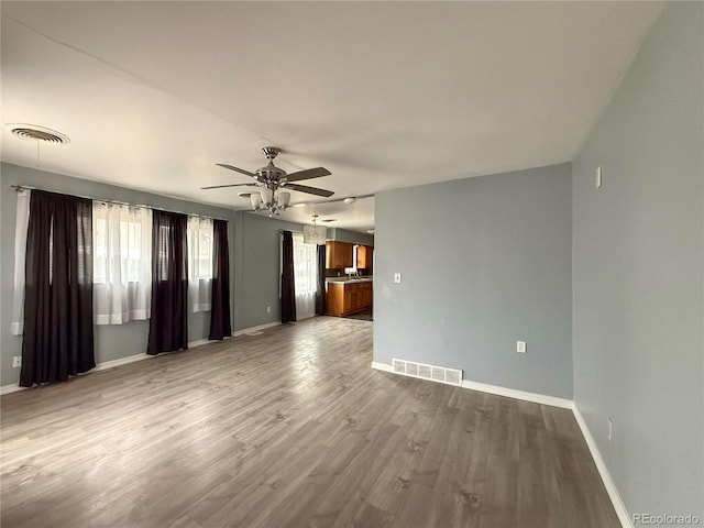 163 Pomeroy St, Burlington, CO 80807 - unfurnished living room featuring healthy amount of natural light, a ceiling fan, and wood finished floors