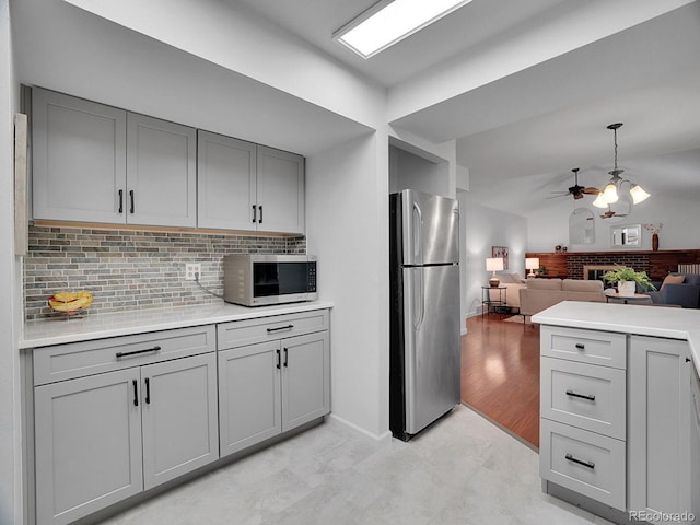 4670 E Euclid Cir, Centennial, CO 80121 - kitchen with stainless steel appliances, gray cabinetry, decorative backsplash, and a ceiling fan