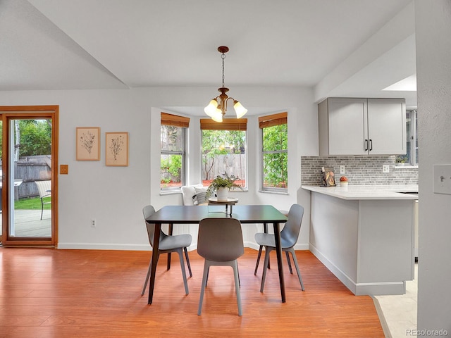 4670 E Euclid Cir, Centennial, CO 80121 - dining area with light wood-style flooring, baseboards, and a chandelier