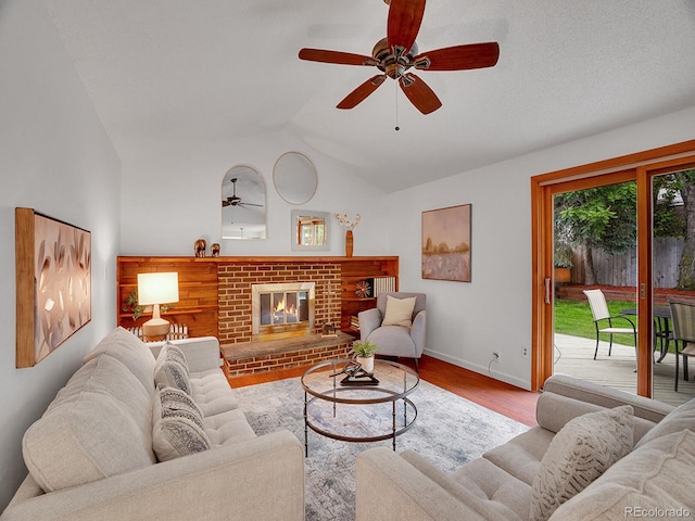 4670 E Euclid Cir, Centennial, CO 80121 - living area with ceiling fan, vaulted ceiling, a fireplace, wood finished floors, and baseboards