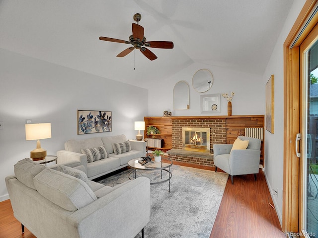 4670 E Euclid Cir, Centennial, CO 80121 - living room with wood finished floors, lofted ceiling, a ceiling fan, and a brick fireplace