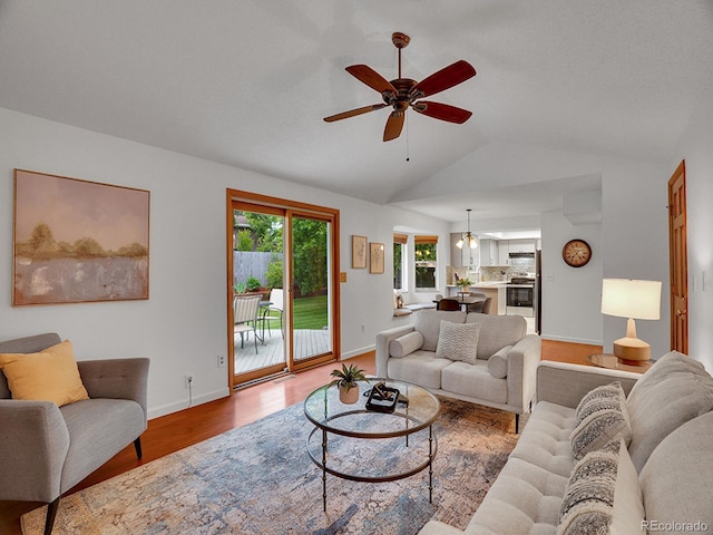 4670 E Euclid Cir, Centennial, CO 80121 - living area with a ceiling fan, vaulted ceiling, wood finished floors, and baseboards