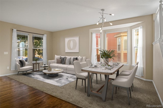 dining area with hardwood / wood-style floors and a chandelier