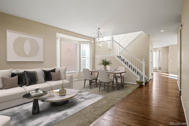 living room featuring dark hardwood / wood-style flooring and an inviting chandelier