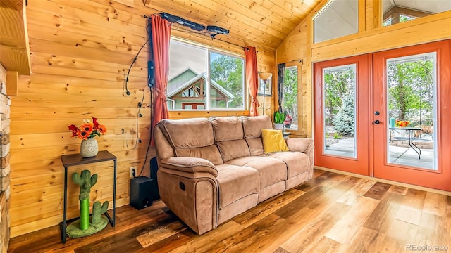 329 River Frontage Unit 14, Silt, CO 81652 - living room with french doors, hardwood / wood-style floors, vaulted ceiling, healthy amount of natural light, and wooden walls