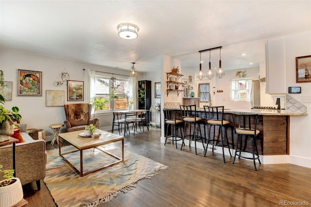 living area with dark wood finished floors and baseboards