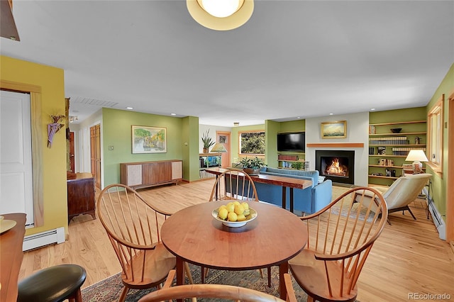 dining room featuring light hardwood / wood-style floors and a baseboard radiator