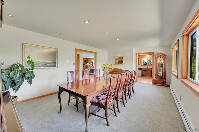 dining space featuring light carpet and a baseboard radiator