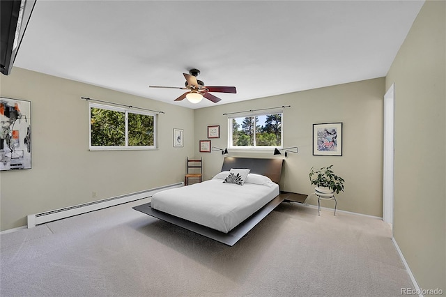 carpeted bedroom featuring baseboard heating and ceiling fan