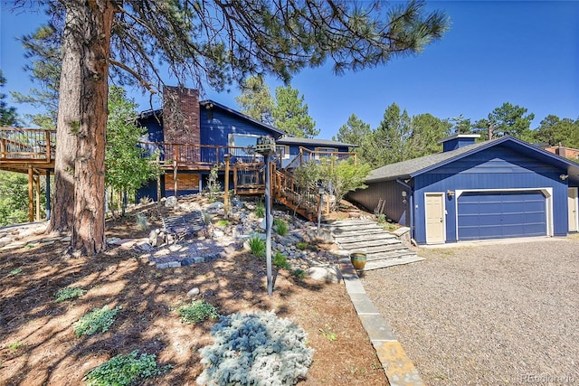 view of front of house with a wooden deck and a garage