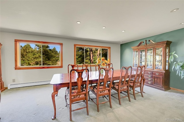 carpeted dining space featuring baseboard heating