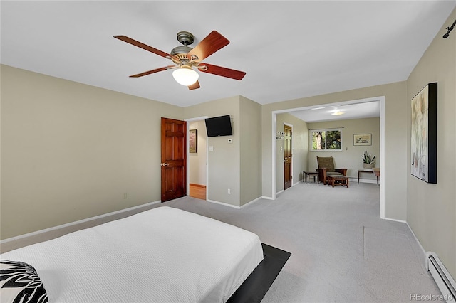 bedroom featuring ceiling fan, light colored carpet, and baseboard heating