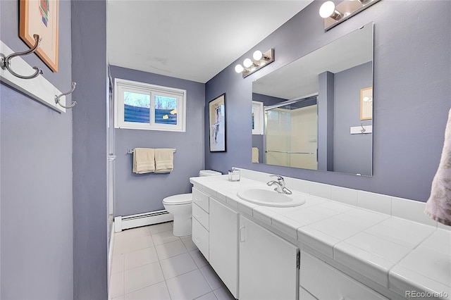 bathroom featuring tile patterned floors, vanity, baseboard heating, a shower, and toilet