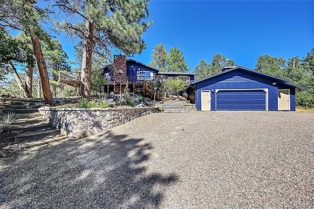 view of front of property with a garage and a deck