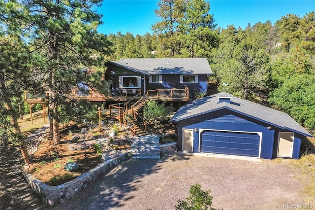 view of front of home with a garage and a deck