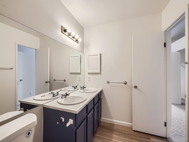 bathroom featuring hardwood / wood-style flooring, vanity, and toilet