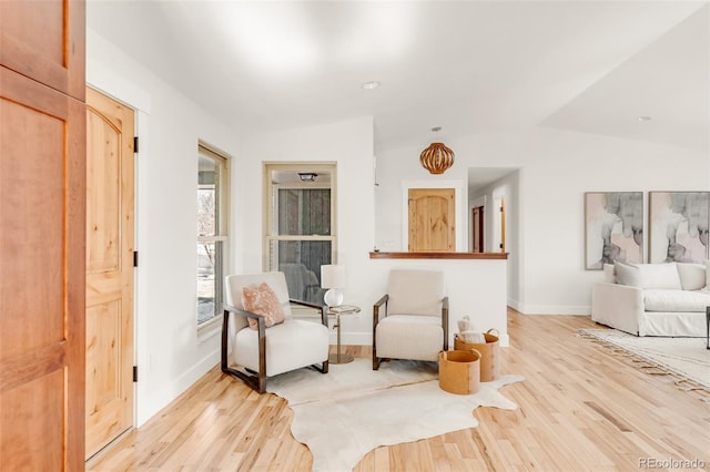 sitting room featuring light wood-style flooring and baseboards