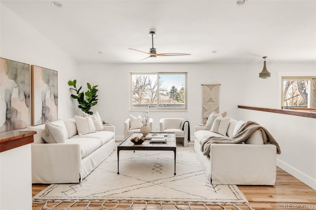 living area with recessed lighting, a ceiling fan, baseboards, and wood finished floors