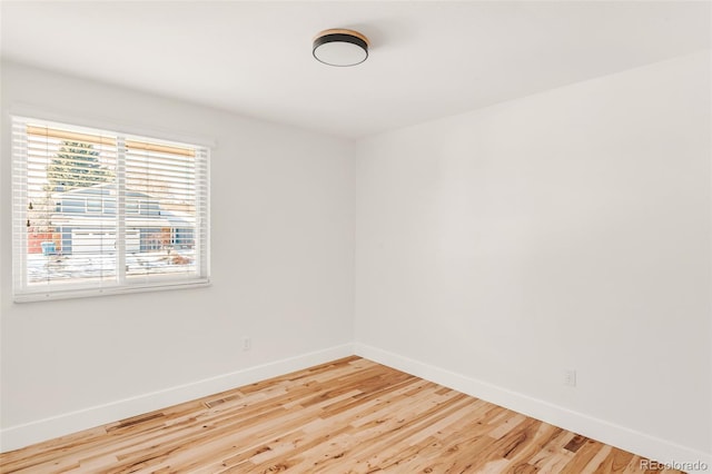 empty room featuring baseboards and wood finished floors