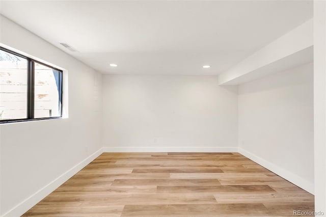 empty room with recessed lighting, baseboards, and light wood-style floors