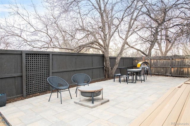 view of patio with outdoor dining area and a fenced backyard